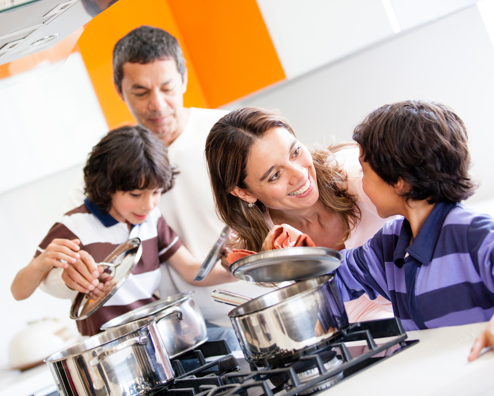 Family cooking together in the kitchen and looking happy