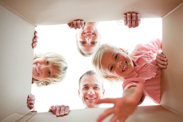 Happy family unpacking boxes in their new house.jpeg