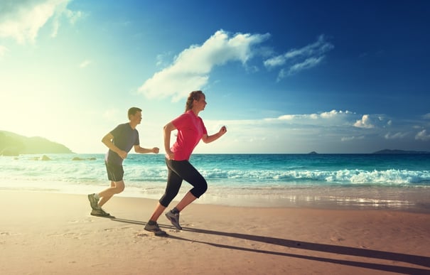 Man and women running on tropical beach at sunset .jpeg