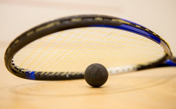 Squash racket with a ball at the court.jpeg